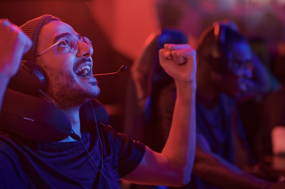Esports player celebrating with a fist pump after a win